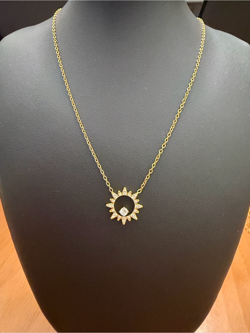 Gold Sunburst Pendant Necklace with White Crystal Accent